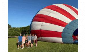 Group Photo of Joe Fromm, Betsy Koonce, Mary Fromm, Jack Fromm, Paul Fromm and Terry Fromm, next to a partially inflated hot air balloon
