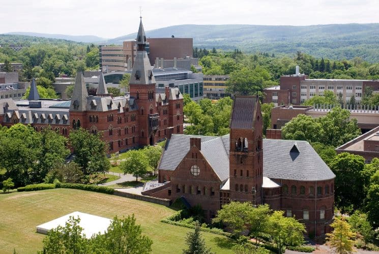 An expansive university campus with many brown buildings and lawn